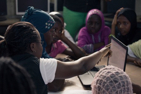 African women accessing data via laptop